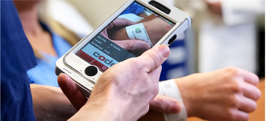 Healthcare worker scanning patient wristband